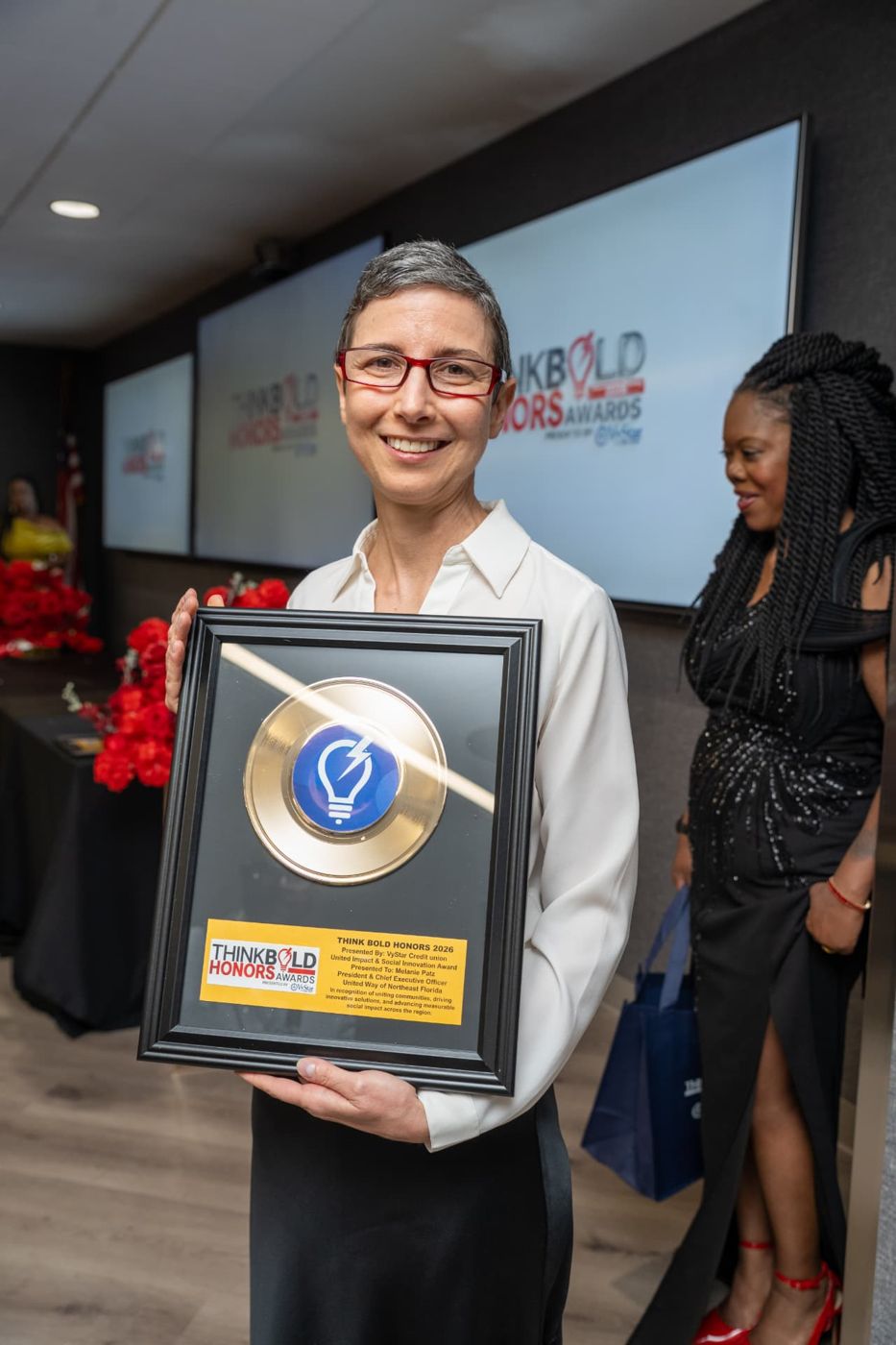 Melanie Patz receiving the United Impact & Social Innovation Award