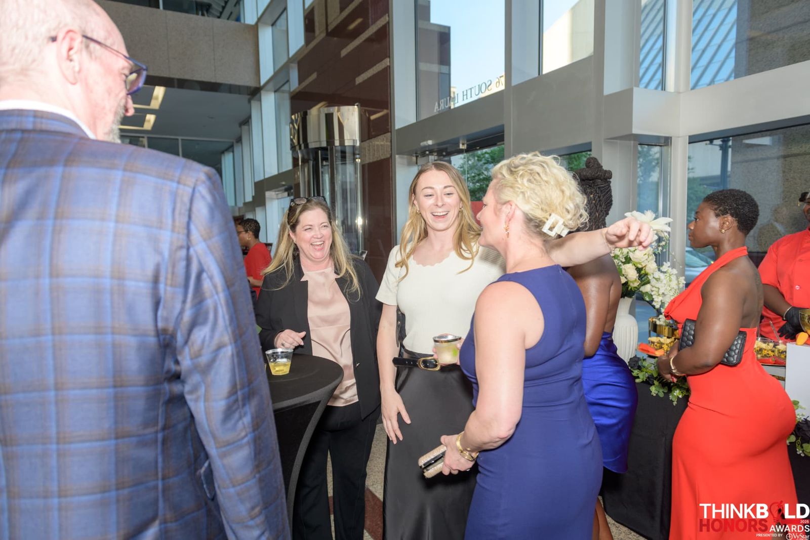 Guests laughing and mingling at the outdoor reception
