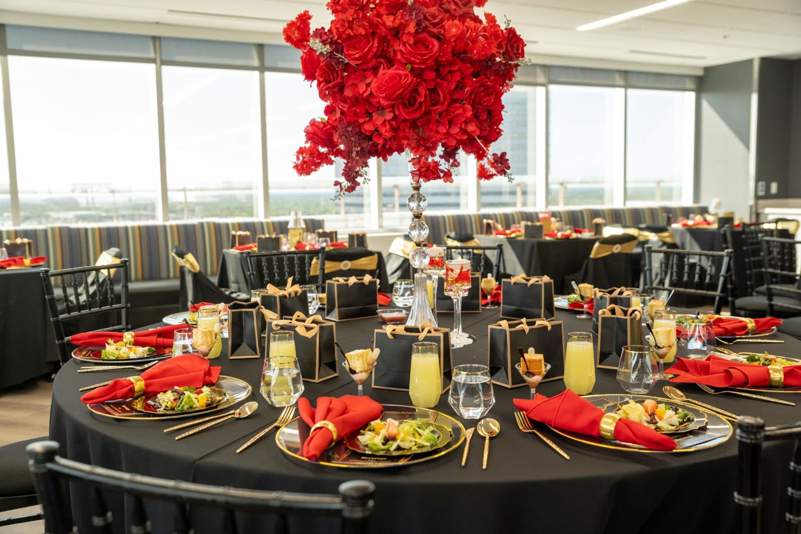 The reception tables dressed in black, red, and gold before guests arrive